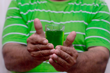St. Patrick's day. Foamy green beer. A glass of green beer close-up.