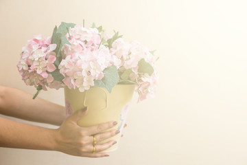 Hand hold buckets of fabric pink flowers