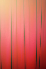 Red closed curtain with a light spo