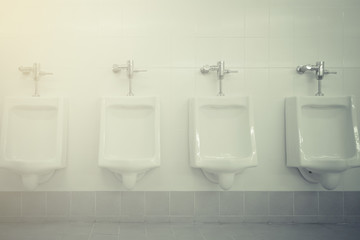 Row of white urinals in men toilet