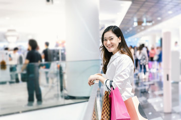 Asian woman smile with shopping bags enjoy in shopping mall 