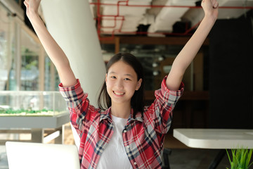 happy woman girl teenager raising hands with gladness happiness