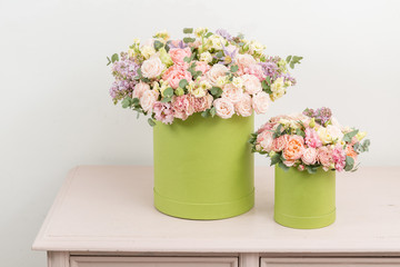 Two Beautiful spring bouquets in head box. Arrangement with mix flowers. The concept of a flower shop, a small family business. Work florist. copy space