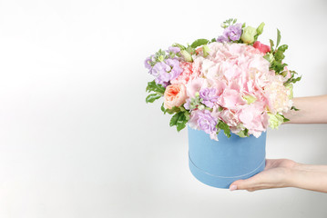 Florist holding a bouquet. Beautiful spring flowers in head box. Arrangement with mix flowers. The concept of a flower shop, a small family business. Work florist. copy space