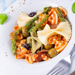 colorful farfalle with green asparagus olives and parma ham