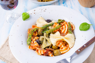 colorful farfalle with green asparagus olives and parma ham