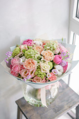 delicate, pastel coloured Small Beautiful bouquet of mixed flowers. Floral shop concept . Beautiful fresh cut bouquet. Flowers delivery