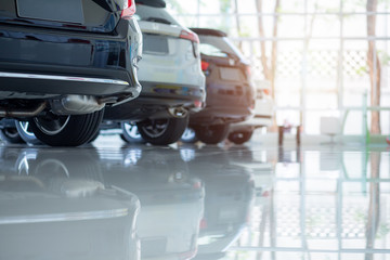 Cars For Sale. Automotive Industry. Cars Dealership Parking Lot. Rows of Brand New Vehicles Awaiting New Owners in the showroom.