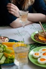A gourmet lunch for two: grilled camembert, fresh vegetables, various appetizers and wine.