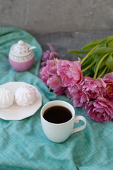 A tasty snack: a cup of coffee and a plate of zefirs.