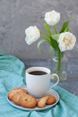 A tasty snack: a cup of coffee and a plate of cookies.