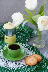 A tasty snack: a cup of coffee and a couple of cookies.