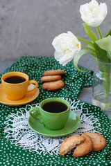 A break for two: cups of coffee, stacks of cookies