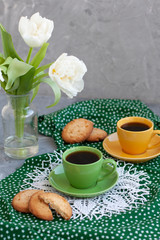 A break for two: cups of coffee, stacks of cookies