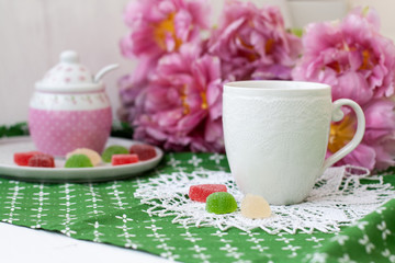 A tasty break: a cup of tea with jelly beans.