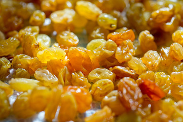 Raisin yellow and light brown scattered on the surface of the fabric close-up shot