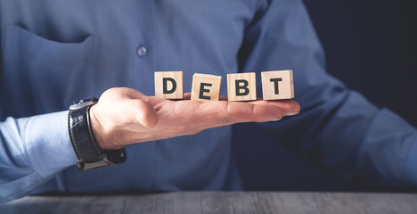 Man holding wooden cubes. Debt. Business concept
