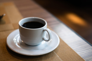 Cup of hot coffee on dinning table in restaurant for breakfast.