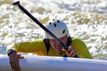 The man fell from supboard (SUP) surfing on the rapids of the whitewater mountain river