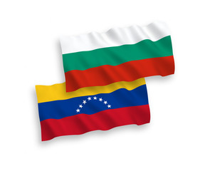 National vector fabric wave flags of Bulgaria and Venezuela isolated on white background. 1 to 2 proportion.
