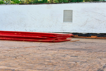 Flat roof repair and replacement in progress. Sheets of stacked plywood on roof sheathing. 