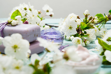 Obraz na płótnie Canvas cosmetics, soaps and cherry flowers