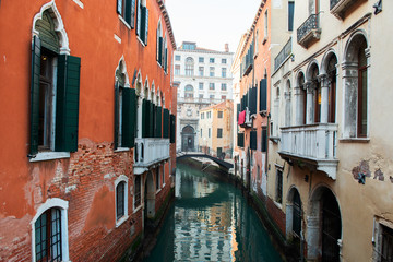 Fototapeta na wymiar Picturesque view of ancient buildings, bridge and channel in Venice, Italy. Beautiful romantic italian city. Unique Venetian landscape.