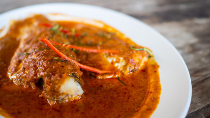 Fried fish toppted with chilli sauce