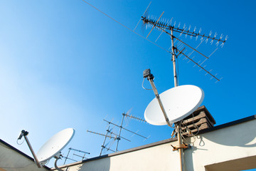 Antennas of satellite and analog television on the roof.