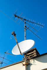 Antennas of satellite and analog television on the roof.
