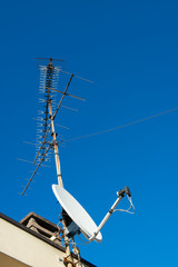 Antennas of satellite and analog television on the roof.