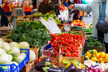 Vegetables and fruit market in Italy. Agricultural food. Fresh organic products. Customers make...