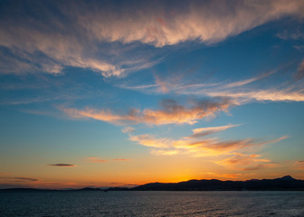 Panoramic view of Mediterranean sea, sky and sun at golden sunset in Palma de Mallorca, Spain.