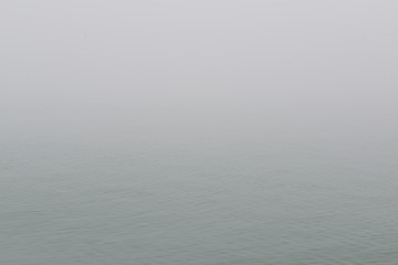 Mediterranean sea in fog. Foggy weather near italian island Burano, province of Venice, Italy.