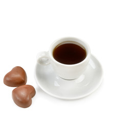 Cup of coffee and chocolate candies isolated on white.
