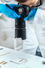 Archaeology Researchers in Laboratory, Documenting Artifacts with Camera