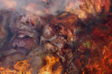Marinated shashlik preparing on a barbecue grill over charcoal. Shashlik or Shish kebab popular in Eastern Europe. Shashlyk, skewered meat. was originally made of lamb.