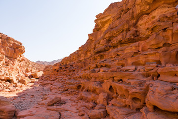 Fototapeta na wymiar Coloured Canyon is a rock formation on South Sinai (Egypt) peninsula. Desert rocks of multicolored sandstone background. 