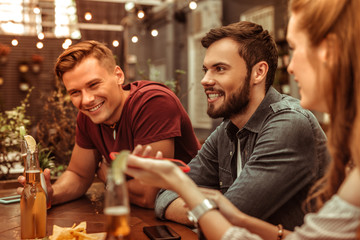 Smiling young-adult two men sitting at the bar table