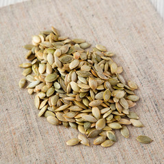 Roasted pumpkin seeds on cloth, low angle view. Closeup.