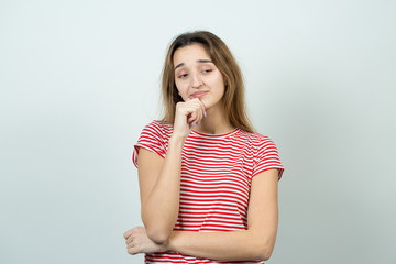 Emotional portrait of a  fair-haired girl on a gray background, stormy emotions, business concept.	