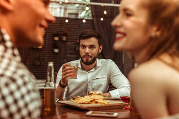 Attractive nice-looking appealing man staring at his flirting friends