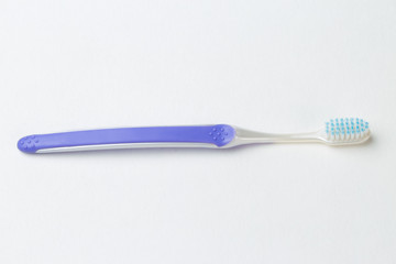 Purple new toothbrush close-up on white background