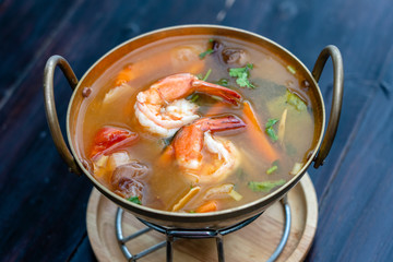 Tom yam kung or Tom yum, Tom yam is a spicy clear soup typical in Thailand. Popular food in Thailand