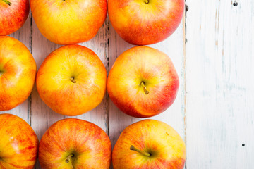 apple fruits in a row, white wooden table background