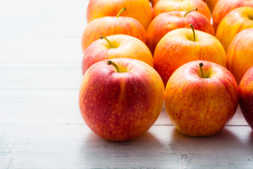 apple fruits in a row, white wooden table background