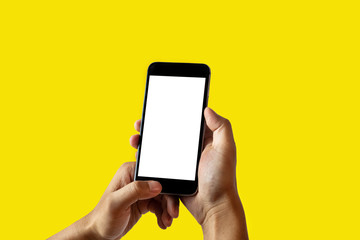 Hand holding the phone with a yellow background.
