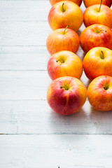 apple fruits in a row, white wooden table background