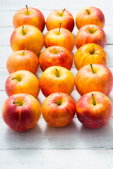 apple fruits in a row, white wooden table background