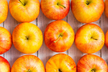 apple fruits in a row, white wooden table background